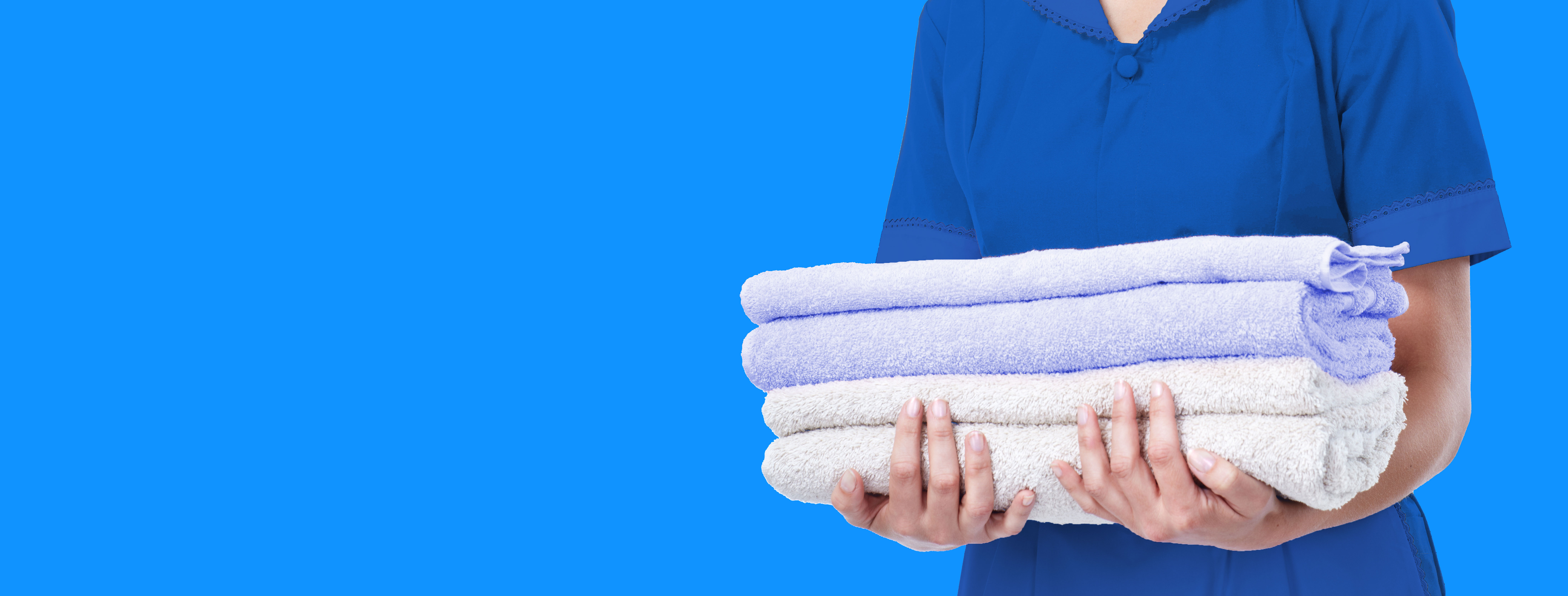 Folded towels on bright blue background